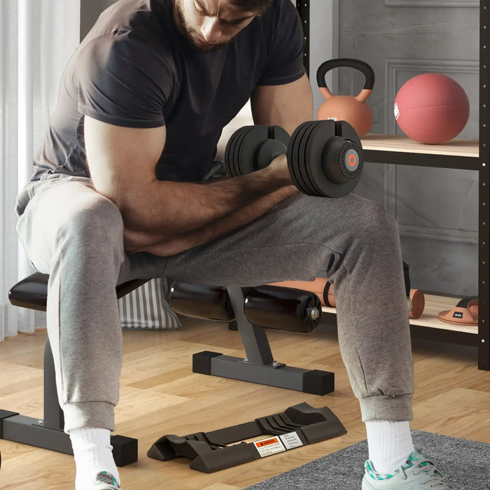 Man exercising with dumbbells in a home gym setting