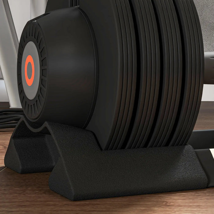 Close-up of a black exercise machine with stacked weights on a wooden floor.