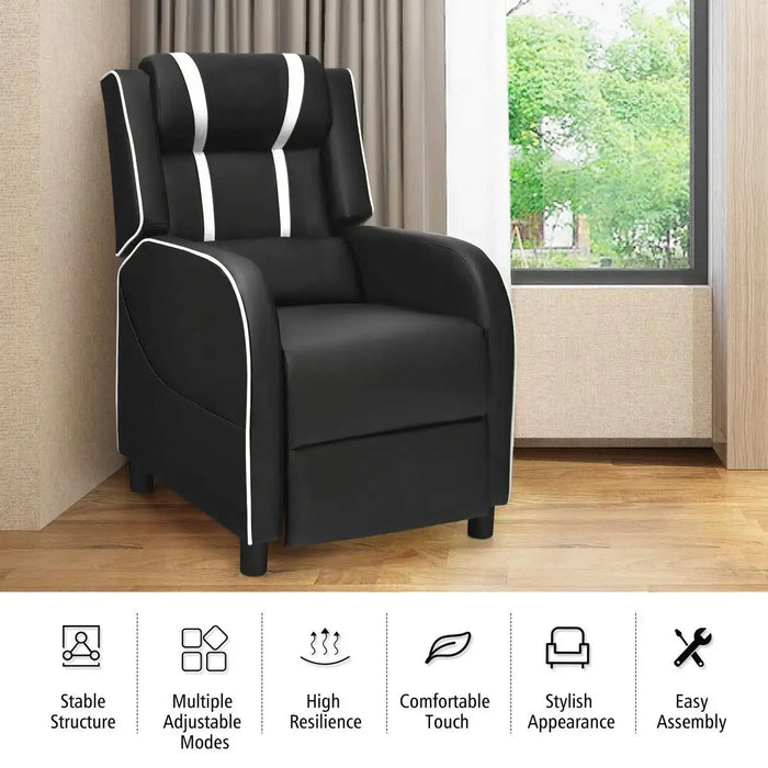 Black recliner chair with white accents in a room with a window and curtains.