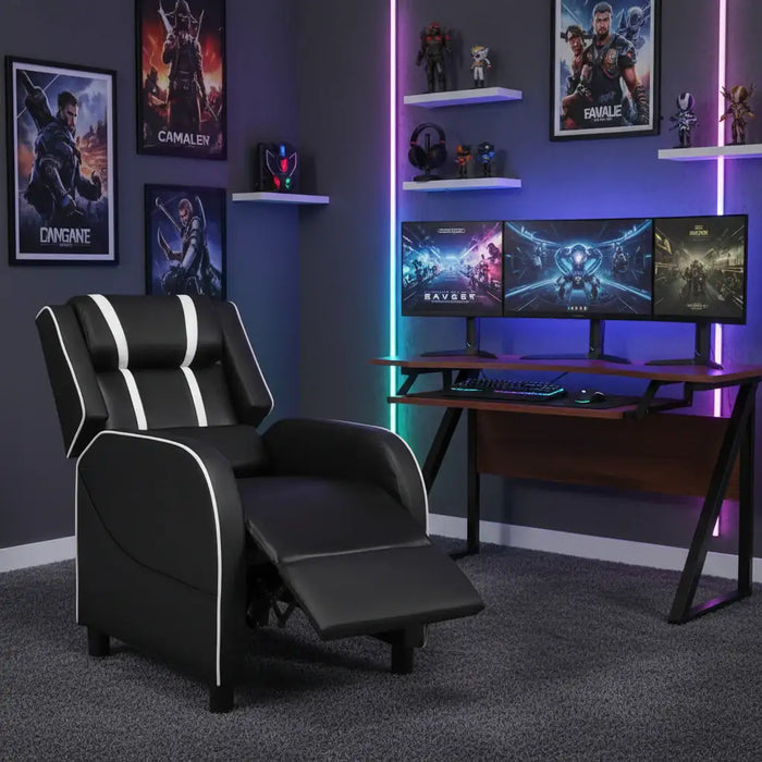 Gaming room setup with a black recliner chair, gaming desk, and multiple monitors.