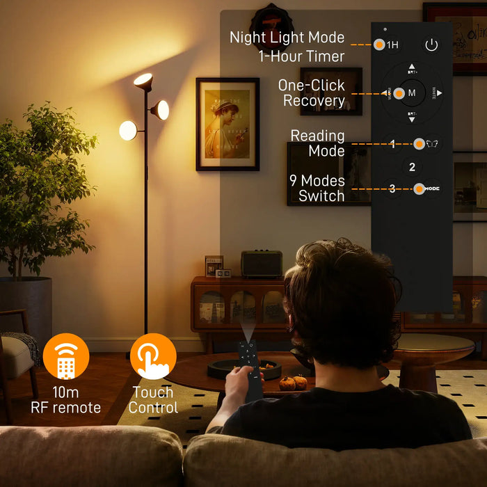 Person using a floor lamp with control panel in a living room