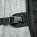 Close-up of a black strap with a buckle on a textured surface