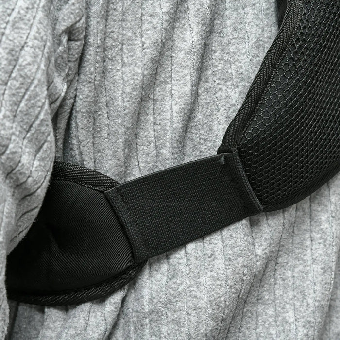 Close-up of a black belt on a textured gray fabric background