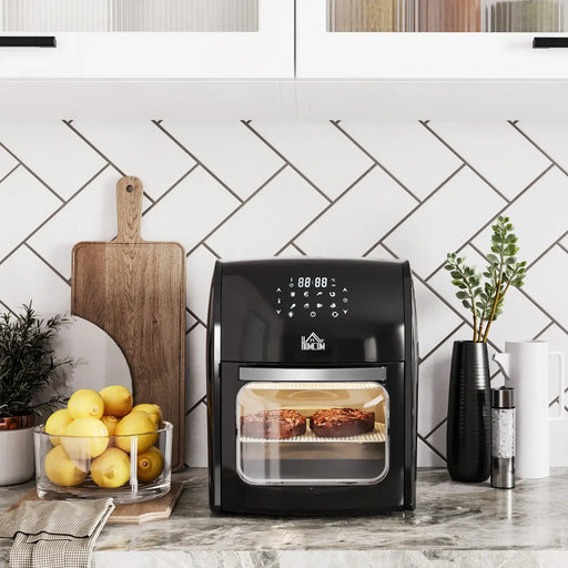 Black air fryer on a kitchen counter with lemons and a cutting board in the background.