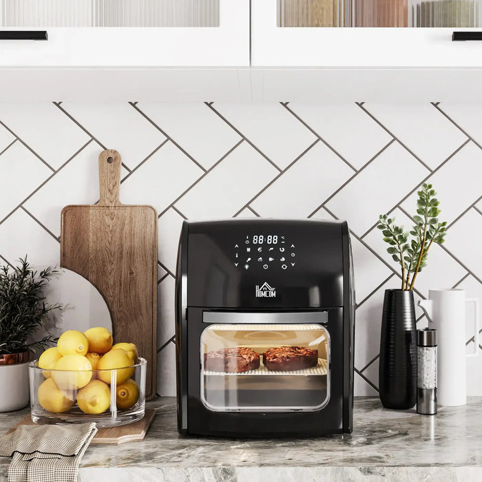 Black air fryer on a kitchen counter with lemons and a cutting board in the background.