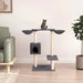 Dark grey multi-level cat tree with baskets, house, sisal posts, and a cat in modern living room