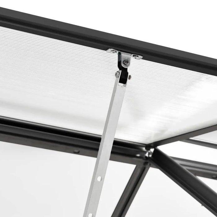 Close-up of aluminum greenhouse polycarbonate panel and metal support bracket.