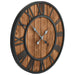 Wooden wall clock with black metal hands and Roman numerals on a white background