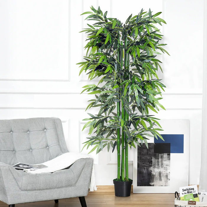 Artificial bamboo plant in a living room setting with a gray sofa and white walls.