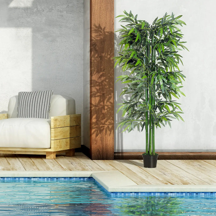 Indoor setting with a white armchair, striped pillow, wooden side table, and a potted plant near a pool.