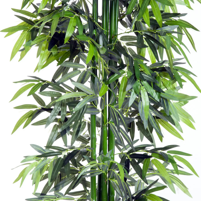 Artificial bamboo plant with green leaves on a white background