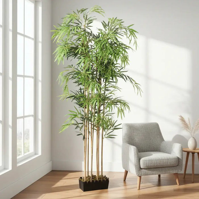 Artificial bamboo plant with green leaves in a plush lounge setting