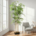 Artificial bamboo plant with green leaves in a plush lounge setting