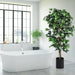 Potted plant in a modern bathroom with a freestanding bathtub and large window.