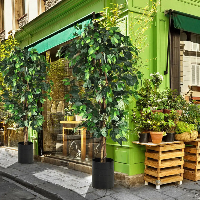 Green storefront with potted plants and wooden crates on a city street.