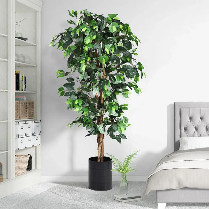 Artificial ficus tree in a bedroom setting with a bed and bookshelf.