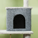 Grey carpeted cat condo with arched entrance and white plush edges against light green wall