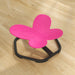 Pink butterfly-shaped stool on a wooden floor