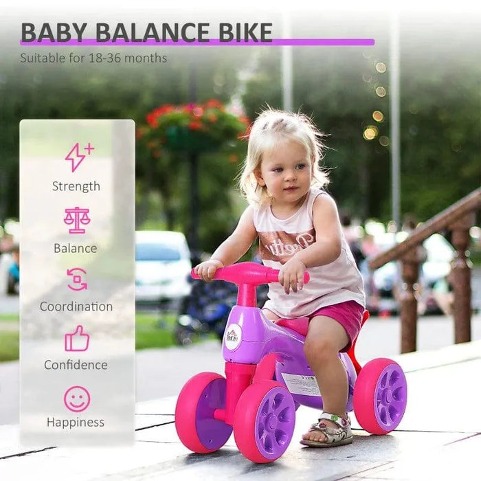 Toddler riding violet and fuchsia baby balance bike with four rubber wheels outdoors