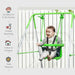 Baby sitting in green toddler swing with safety belt, indoor and outdoor use, white fence background.