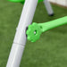 Close-up of green plastic knob on toddler swing frame, outdoor grass setting