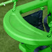 Green toddler swing seat with safety belt and ropes for indoor or outdoor play on grass