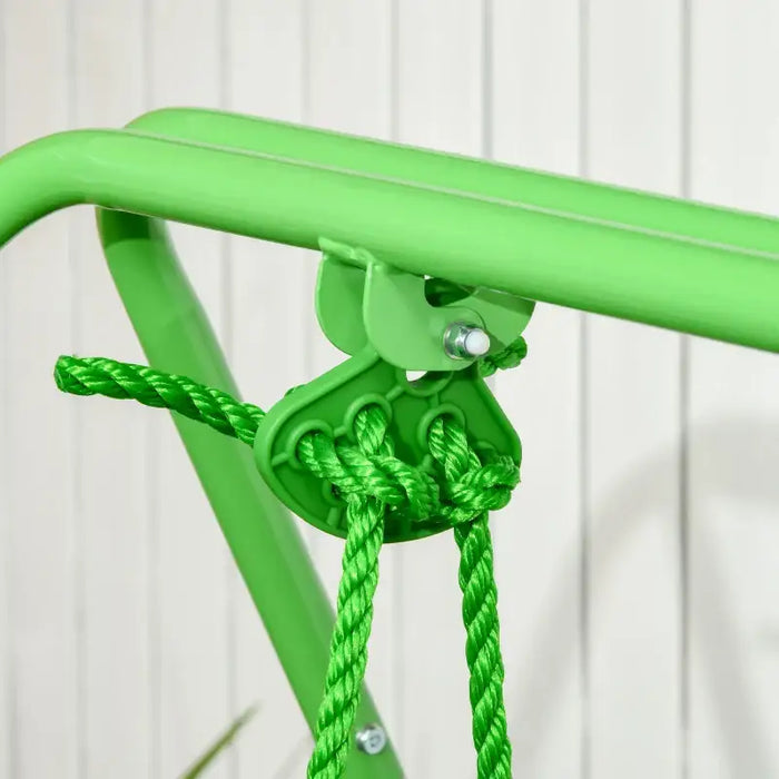 Close-up of green toddler swing rope attachment on metal frame, indoor setup