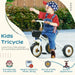 Toddler riding white adjustable kids tricycle with bell and basket outdoors, wearing star cap and overalls