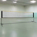 Badminton net with steel frame and adjustable height in an indoor sports hall