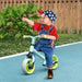 Toddler on balance bike with adjustable seat and EVA wheels outdoors on blue path