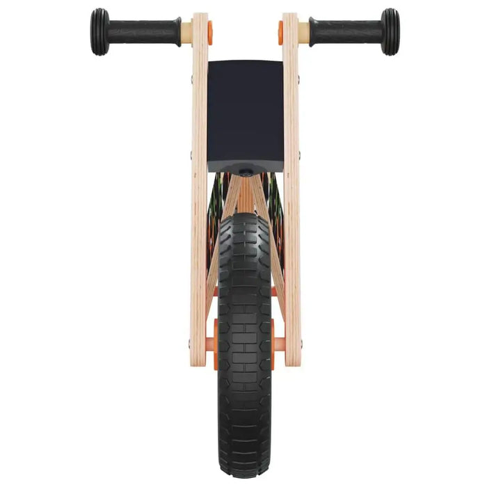 Front view of orange and black balance bike with lightweight plywood frame and rubber grips