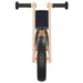 Front view of orange and black balance bike with lightweight plywood frame and rubber grips