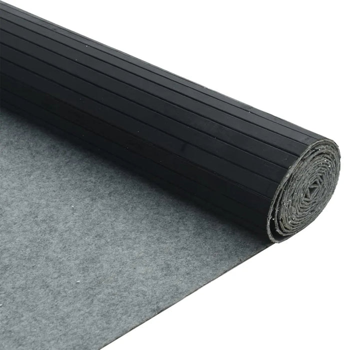 Roll of black protective film on a gray surface