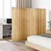 Wooden screen partition in a room with a bed and desk.