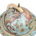Vintage-style world globe with decorative elements on a white background