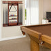 Pool table with cue rack and pool balls in a room with a window and television.