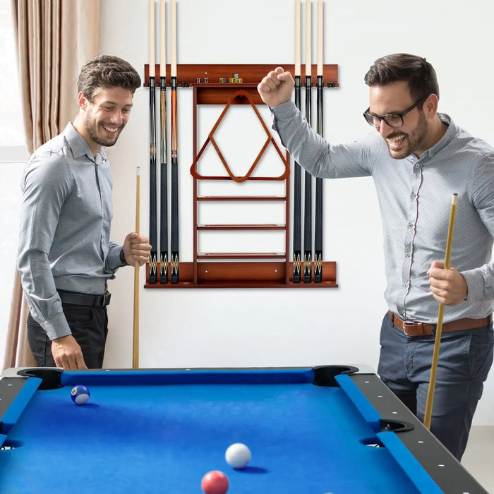 Two men playing pool in a room with a pool table and cue rack.