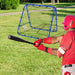 Baseball player in red batting toward blue rebounder net on grass field