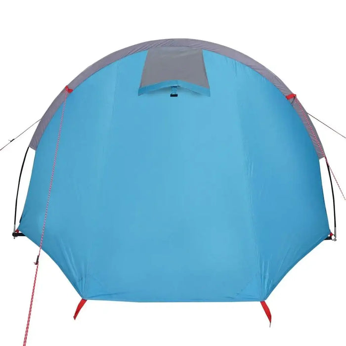 Blue taffeta 4-person camping tent with guy lines and gray top panel