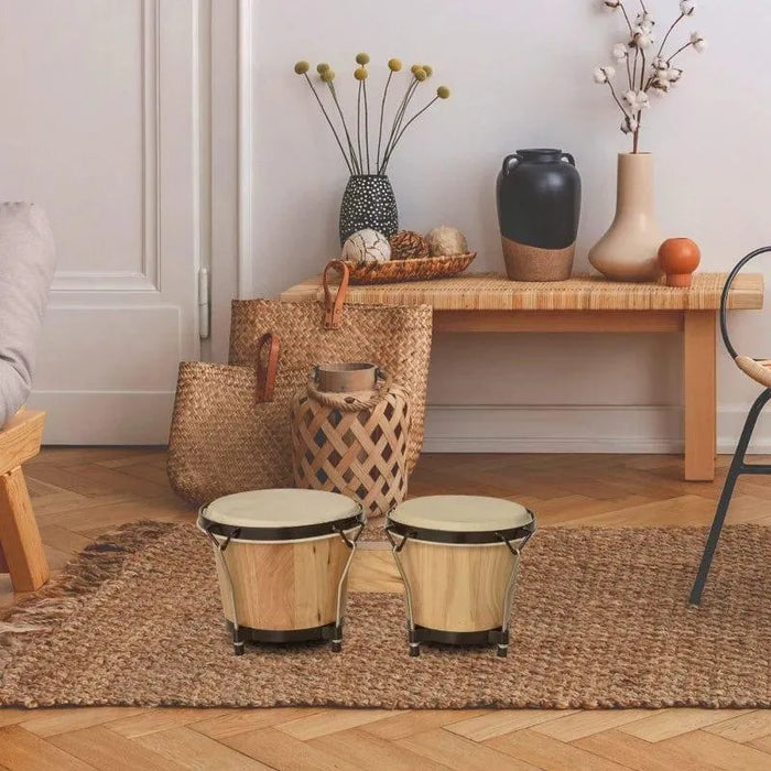 Bongo drum set with natural sheepskin heads on woven rug in cozy living room decor