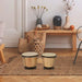 Bongo drum set with natural sheepskin heads on woven rug in cozy living room decor