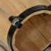 Close-up of natural wood bongo drum with black rim and tuning hardware