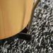 Close-up of bongo drum tuning hardware on patterned carpet