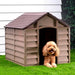 Brown plastic dog house with a fluffy dog on grass, outdoor weather-resistant kennel