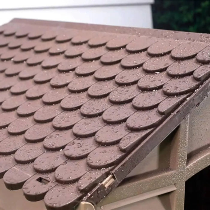 Brown plastic dog house roof with raindrops, weather-resistant outdoor kennel