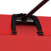 Close-up of red camping bed fabric with black steel frame and reinforced stitching
