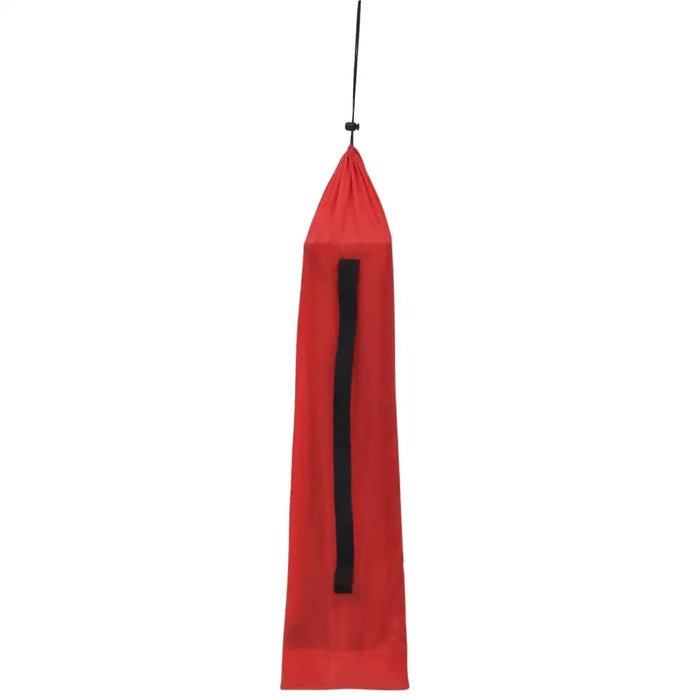 Red portable camping bed carry bag with black handle, hanging vertically