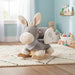 Gray and beige donkey-shaped rocking toy in a plush bedroom