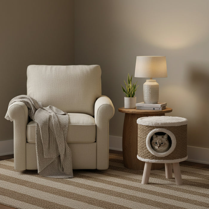 Brown elevated cat house condo with seagrass scratching carpet beside cozy armchair