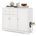 White side cabinet with storage doors and drawers, decorated with books and decor, cat entering side litter box